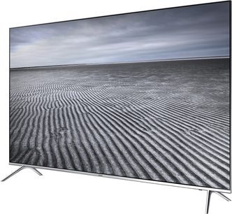 Samsung UE49KS7000 fladskærms-TV med bølgede linjer på en grå, overskyet himmel i baggrunden