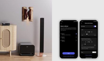 Musta etuportillinen subwoofer, musta lattiakaiutin kuparinsävyisellä jalustalla, vaalea puuhuonekalu, kaksi älypuhelinta