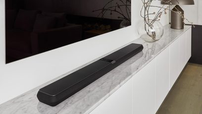Black Bowers & Wilkins Panorama 3 soundbar placed on a white marble cabinet, front and top view