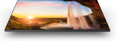 Samsung QE43Q65A 2021 fladskærms-TV, der viser et naturligt landskab med solnedgang, flod og vandfald mellem klipper