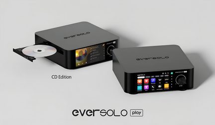 Two compact audio units in matte black aluminum, three-quarter front view, rounded finish with engraved logo on top, front panel featuring a color display and a large dial, the left model showing an open CD tray with disc