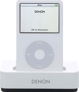 Front view of white Denon ASD-1R multimedia dock, LCD screen displaying "OK to disconnect", silver control wheel
