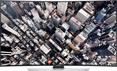 Televizor Samsung UE55HU8500 s plochou obrazovkou zobrazující hustý letecký pohled na mrakodrapy velkoměsta