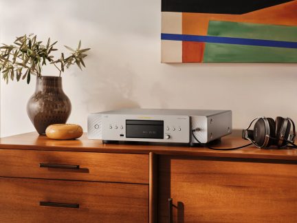 Hõbedane Marantz CD 50n võrgu-CD-mängija koos Bowers & Wilkins kõrvaklappidega puidust kapil