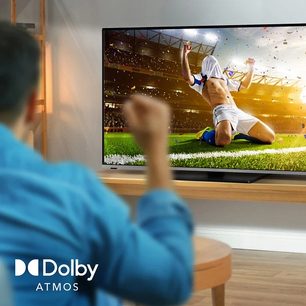 Dolby Atmos-fjernsyn der viser en fodboldspiller i aktion på en bane, set forfra i nærbillede