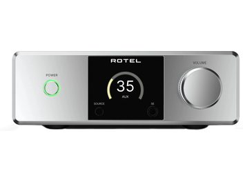Amplificador hi-fi estéreo integrado Rotel DX-5 prata, gabinete em alumínio escovado, vista frontal com tela central preta e indicador digital, botão de energia com LED verde à esquerda e grande botão de volume prateado à direita