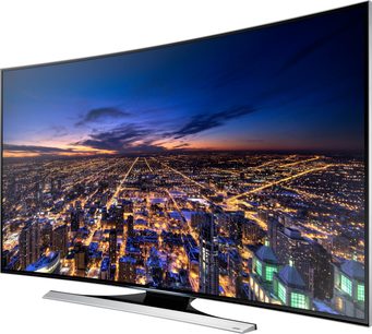 Samsung UE65HU8200 buet TV viser et natligt luftfoto af en oplyst storby med tætpakkede bygninger