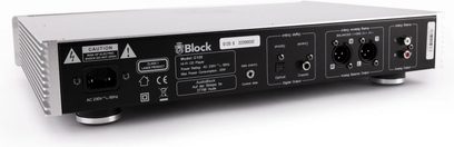 CD-Player Block C-120 aus schwarzem und gebürstetem silbernem Metall, Rückansicht in leichter Dreiviertelperspektive, zeigt IEC-Anschluss, optische und koaxiale Ausgänge, zwei XLR- und RCA-Paare, seitlich belüftetes Gehäuse und runde Standfüße