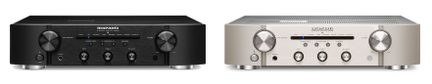 Two black audio amplifiers, one with knobs and the other with knobs and dials, viewed from the front