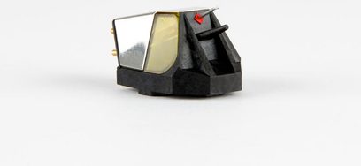 Rega Nd7 turntable cartridge, three-quarter view, black body, silver metallic details, visible stylus