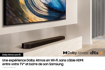 Samsung HW-Q710D sort soundbar, set forfra, placeret på hvidt TV-møbel, under skærm der viser blå og gylden bølge
