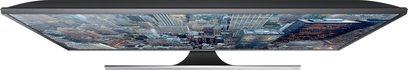 Samsung UE85JU7000 ultrafladskærms-TV, bredformat, frontvisning, smal sort ramme, billede af en futuristisk by på skærmen