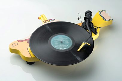 Pro-Ject Yellow Submarine hi-fi turntable with a black circular platter, curved black tonearm, and a yellow submarine-shaped base