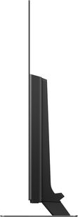 Panasonic TX-65EZ950E-fladskærms-tv, set fra siden, rektangulært sort fladskærms-panel på smal lodret metalfod