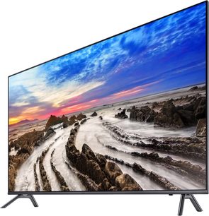 Samsung UE65MU7045 65" TV viser et klippefyldt kystlandskab ved solnedgang med en farverig himmel