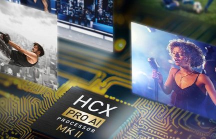 Primer plano en vista oblicua de un microprocesador cuadrado con carcasa negra mate que lleva la inscripción «HCX PRO AI PROCESSOR MK II», montado en un circuito impreso verde-azulado con pistas doradas y rodeado de pequeñas viñetas de imágenes desenfocadas.