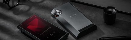 Bærbar lydafspiller Kann i mørk metallisk grå med skærm, drejeknap, hovedtelefoner, på læderimiteret etui