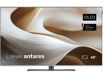 Loewe Antares 48-tolline OLED-teler, õhuke ekraan hallil keskjalaalusel, beeži ja pruuni abstraktse kujutisega