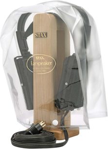 STAX CPC-1 protective cover made of flexible transparent plastic, front view, bell-shaped with two white snap buttons at the base and a central gold logo, revealing the light wood headphone stand and the black headphones inside