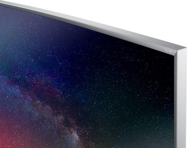 Samsung UE65JS9500 fladskærms-TV med sølvfarvet kant, der viser et billede af Mælkevejen mod en nattehimmel med blå baggrund og stjerner