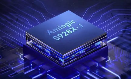 Angled view of an Amlogic S928X-J processor, smooth top surface, blue printed circuit boards in the background