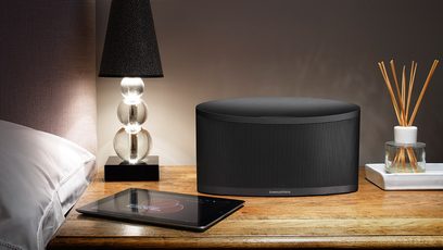Bowers & Wilkins Z2 sort multimedie-højttaler, bordlampe, glaskuppel, tablet, duftpinde på træbord