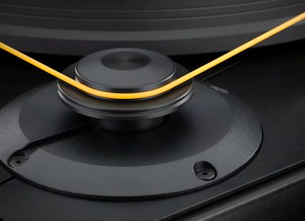 Tocadiscos de vinilo negro con tracción por correa, primer plano de la polea del motor y la correa naranja