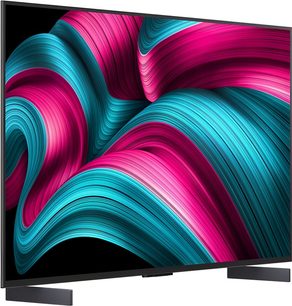 LG OLED42C5 2025, επίπεδη μαύρη τηλεόραση με εξαιρετικά λεπτό μεταλλικό πλαίσιο, εξοπλισμένη με δύο σκούρα ορθογώνια πόδια, λαμπερή οθόνη OLED που προβάλλει αφηρημένο μοτίβο σε ροζ και τιρκουάζ, τρισδιάστατη όψη από δεξιά εμπρός