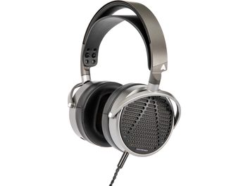 Open-back Audeze MM-100 headphones in silver and black metal, viewed from the left profile, with perforated grilles on the earcups