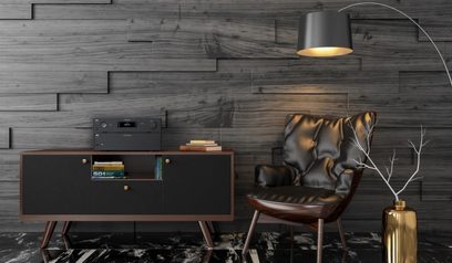 Amplificador NAD C298 negro, sillón de cuero marrón, lámpara dorada, pared de madera, vista frontal