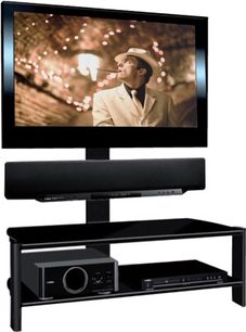 Sort TV-møbel med hylde, fladskærmsbeslag og indbygget DVD-afspiller. Skærmen viser et billede af en mand i hvid habit, der smiler.