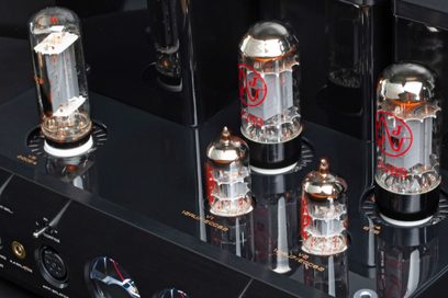 Cayin HA-3A high-fidelity headphone preamplifier in black lacquered metal with six visible glass tubes, gold inscriptions, and an equipped front panel, close-up three-quarter front view