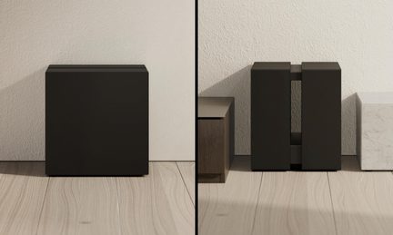 Sort subwoofer med rektangulært design, set forfra og fra siden med central åbning på siden