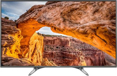 Televisão Panasonic TX-55DX600E exibindo um arco natural laranja em um cânion rochoso, vista frontal