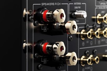 Yamaha R-N2000A silver hi-fi stereo amplifier, close-up of the RCA audio input jacks and speaker output terminals