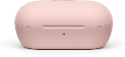 Matowe, różowe etui ładujące z tworzywa sztucznego, widok z przodu na Sony WF-C710N, kompaktowy, owalny kształt z poziomym rowkiem do otwierania i przednią diodą LED sygnalizującą stan