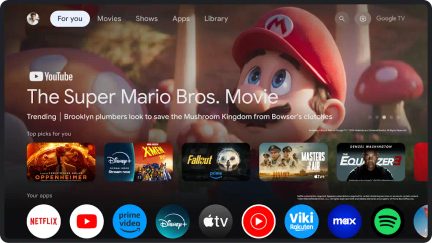 Gränssnitt Google TV, horisontell visning, appikoner längst ner, bild av animerad karaktär med röd keps i bakgrunden