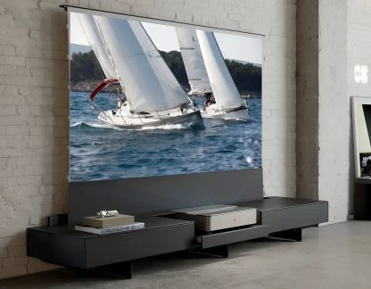 Wall-mounted pull-down projection screen displaying two white sailboats at sea in a modern black living room