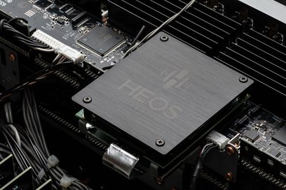HDAM audio processor on black printed circuit board in brushed metal casing, close-up top view at a slight angle