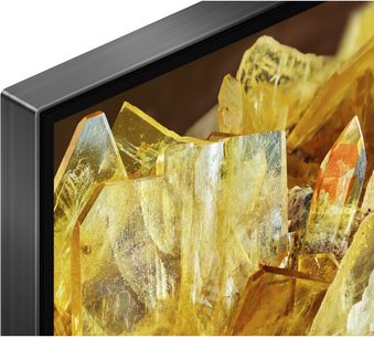 Sony XR85X90L, øverste venstre hjørne, sort metalramme, skærm viser gule krystaller, nærbillede