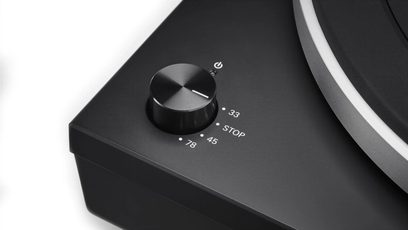 Sort Audio Technica AT-LP5X pladespiller, nærbillede i fugleperspektiv af kontrolknappen og den aluminiumstonearmen