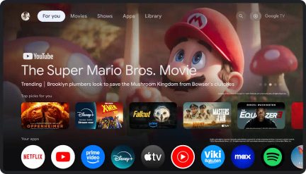 Ekran główny Google TV z obrazem Mario w czerwonej czapce, ikonami aplikacji i sugestiami filmów