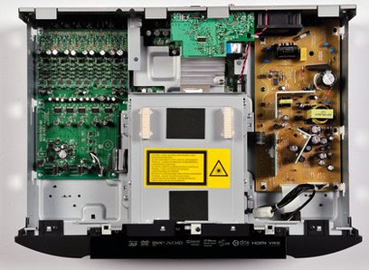 Åben sort Marantz UD7006 Blu-ray-afspiller, indvendigt syn af elektroniske komponenter, grønne printplader, sølvfarvede mekanismer