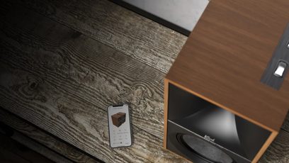 Bezdrátová chytrá reproduktorová soustava Klipsch The Nines v ořechovém provedení, detailní pohled z úhlu, texturovaný dřevěný povrch, ovládací panel