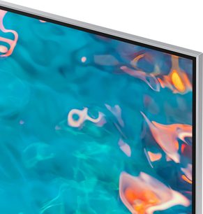 Samsung QE85QN85A TV som viser fargerike turkise og oransje abstrakte former mot en mørkeblå bakgrunn, sett fra siden