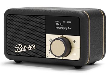 Roberts Revival Petite 2 compact table radio, three-quarter front view, black textured faux leather casing with gold trim, front panel featuring a black metal speaker grille with Roberts logo, small black digital display, and gold control panel with a large central rotary knob.