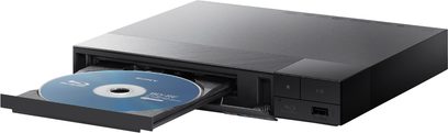 Sony BDP-S1700K 4K Blu-ray-afspiller sort med åben skuffe, der indeholder en blå disk, og frontpanel med knapper og USB-port