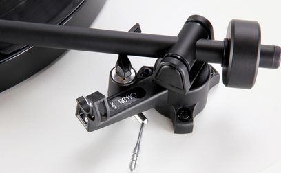 Rega Planar 1 matte white turntable, close-up view of black tonearm with cartridge, on white background