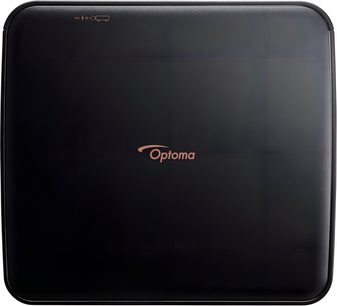 Matný černý plastový projektor Optoma Photon Life PK32, pohled shora, pouzdro se zaoblenými rohy, měděné centrální logo