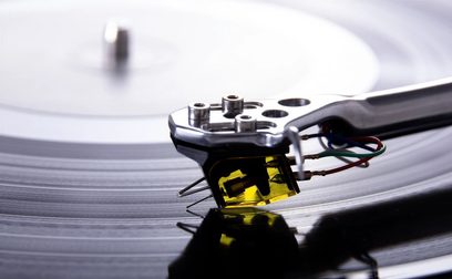 Rega Aphelion 2 MC sort pladespillercelle, tæt ovenfra-udsigt, med arm og kabler synlige på vinylplade